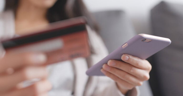 woman using phone and credit card at home 2026 03 25 00 20 32 utc scaled